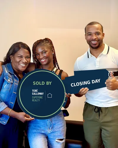 Teré with two buyers holding a Sold by Teré Calloway key on closing day
