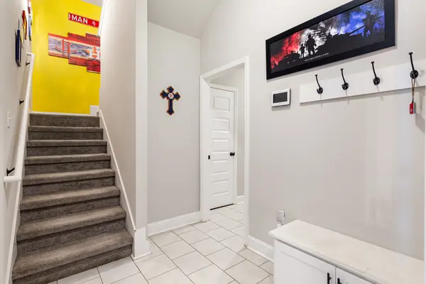 Stairs and mud room with boot bench