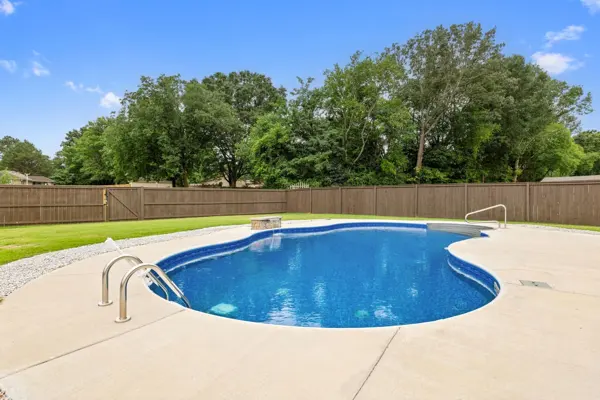 In-ground pool and fenced back yard