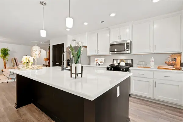 White cabinetry, tile backsplash, stainless appliances